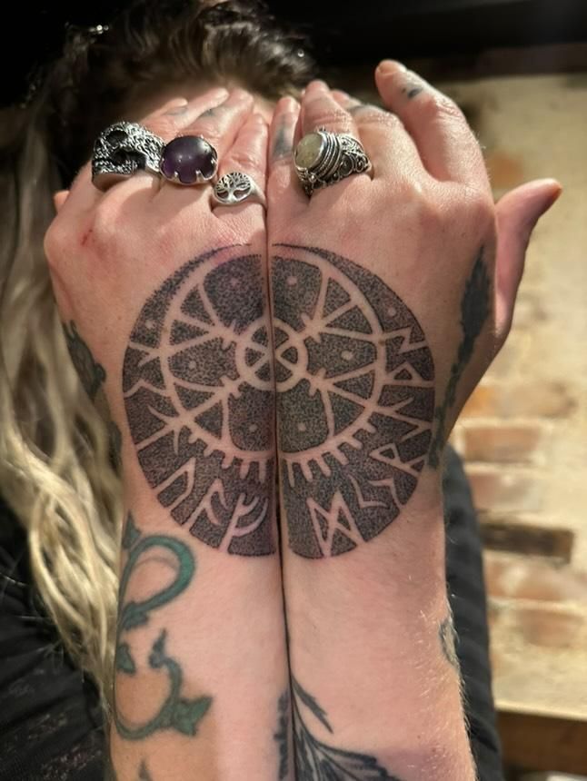 a dotwork tattoo in icelandic/nordic style., spanning the back of two hands